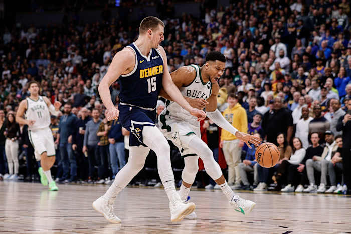 Milwaukee Bucks forward Giannis Antetokounmpo (34) drives to the basket against Denver Nuggets center Nikola Jokic (15) 